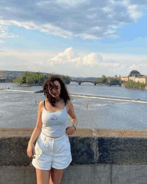 a woman wearing a white tank top that says ' i love you ' on it