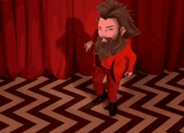 a man with a beard is standing in front of a red curtain on a chevron floor