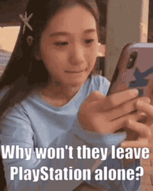 a girl is looking at her phone and says `` why won t they leave playstation alone ? ''