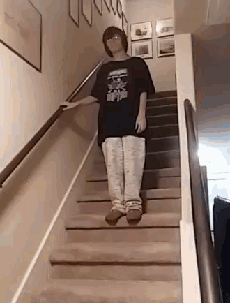 a person is standing on a set of stairs wearing a black shirt that says harry potter .