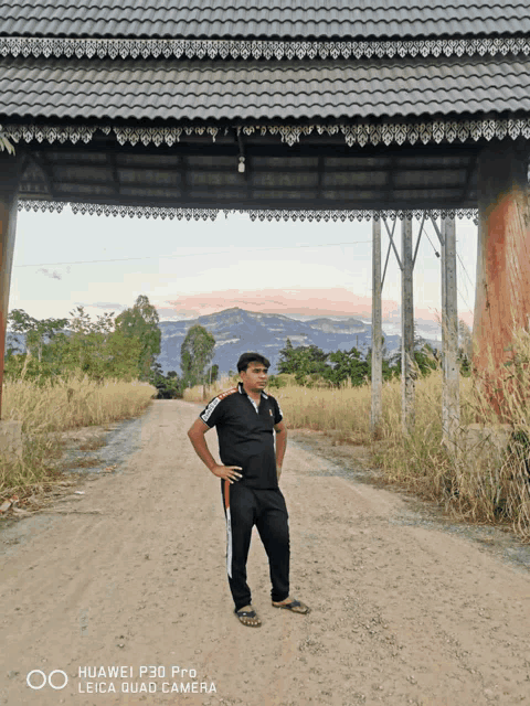 a huawei p30 pro leica quad camera takes a picture of a man standing in the dirt