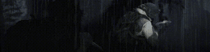 it is a black and white photo of a person standing in the rain .