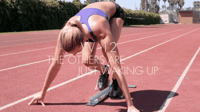 a woman getting ready to run on a track with the words " the others are just waking up " above her