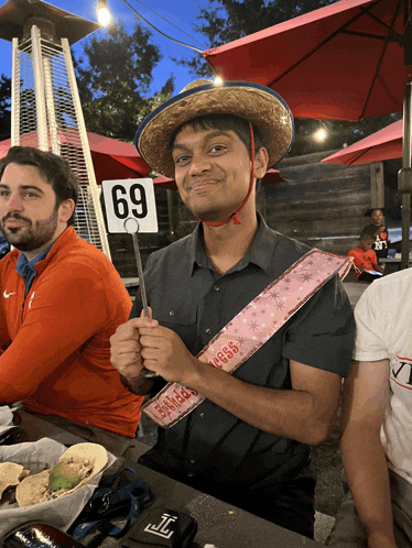 a man wearing a sombrero and a sash that says ' i 'm a bride ' on it