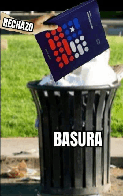 a person throws a book into a trash can with the word basura on it