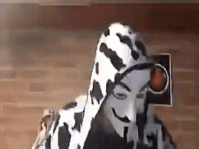 a person wearing a dalmatian costume and a mask