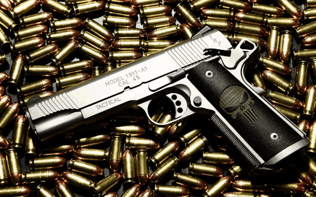 a model 1911 a1 tactical gun is laying on top of a pile of bullets