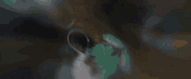 a close up of a man 's face wearing a white hoodie .