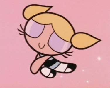 bubbles from the powerpuff girls is sitting on the ground with her eyes closed .
