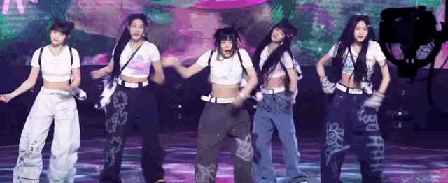 a group of women are dancing on a stage .