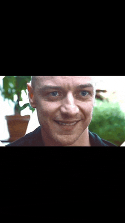 a close up of a man 's face with blue eyes