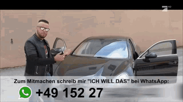 a man standing next to a car with a phone number + 49 152 27