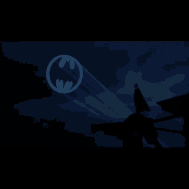 a man in a cape stands on a roof in front of a batman logo