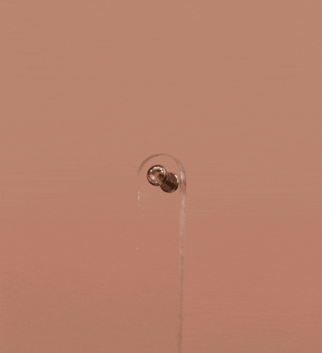 a close up of a piece of metal with a screw in it