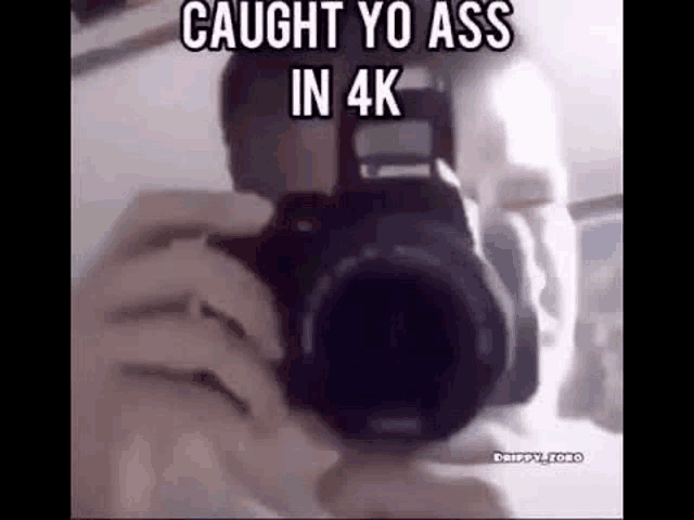 a man is taking a picture of himself with a camera in 4k .