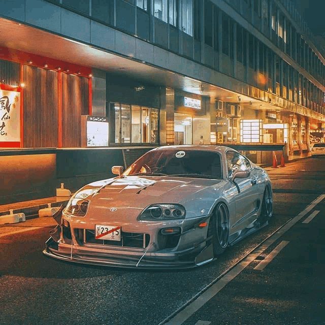 a silver sports car with a license plate that says 932