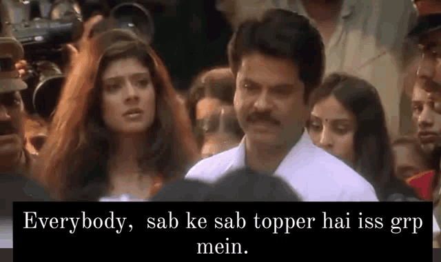 a man with a mustache is standing in front of a crowd with a caption that says everybody sab ke sab topper hai