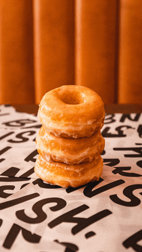 three donuts are stacked on top of each other on a table