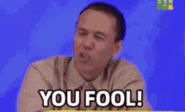 a man in a suit and tie is saying you fool