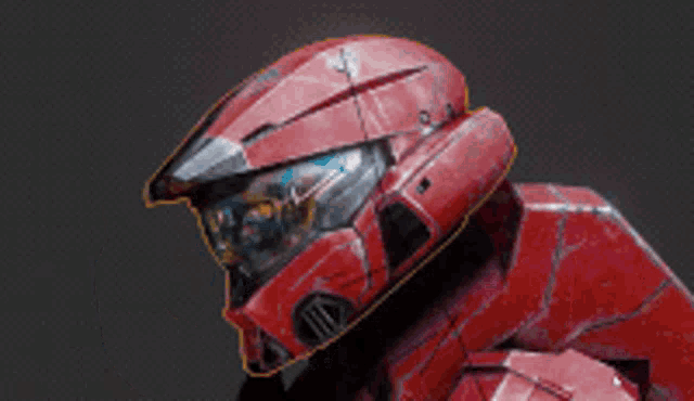 a close up of a red robot 's head on a black background