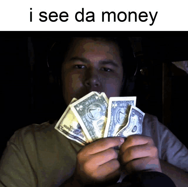 a man is holding a bunch of money with the caption i see da money above him