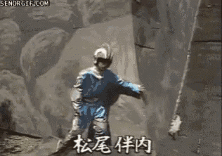 a man is riding a roller coaster with a large rock .