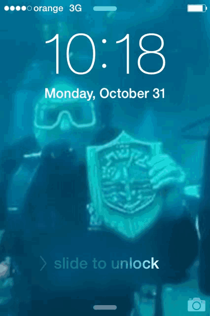 a phone screen shows a picture of a scuba diver on monday october 31st