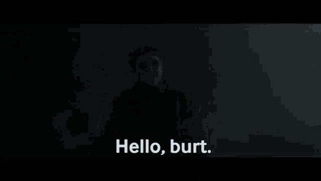 a man wearing sunglasses is standing in the dark and saying `` hello , burt . ''