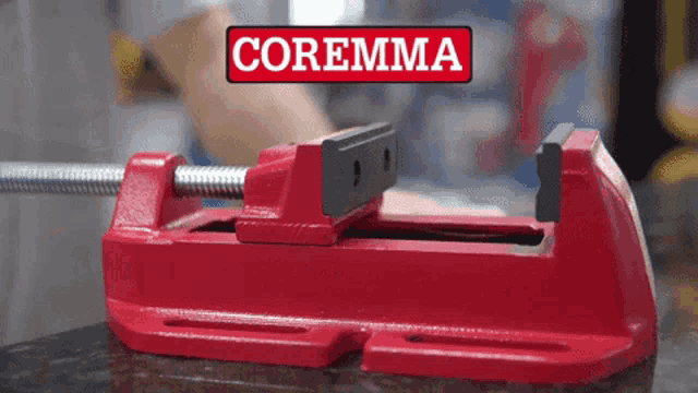 a red coremma vise is sitting on a counter