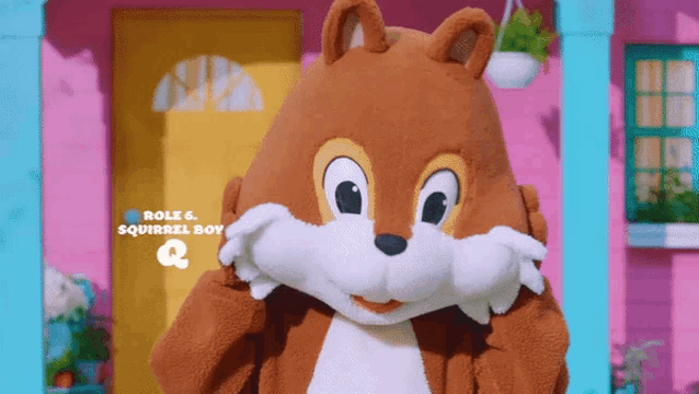 a squirrel boy mascot covering his face with his hands