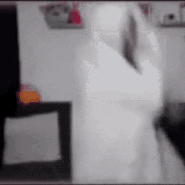 a blurred image of a person in a white robe