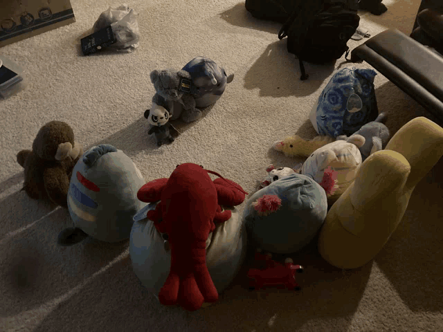 a bunch of stuffed animals sitting on the floor