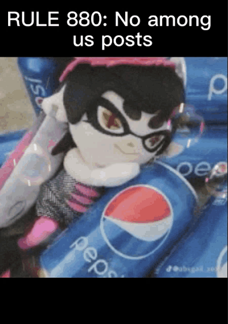 a stuffed animal laying on top of pepsi cans