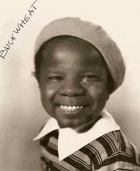 a black and white photo of a young boy wearing a striped shirt and a beret .