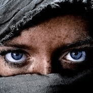 a close up of a person 's face with a scarf around their face .