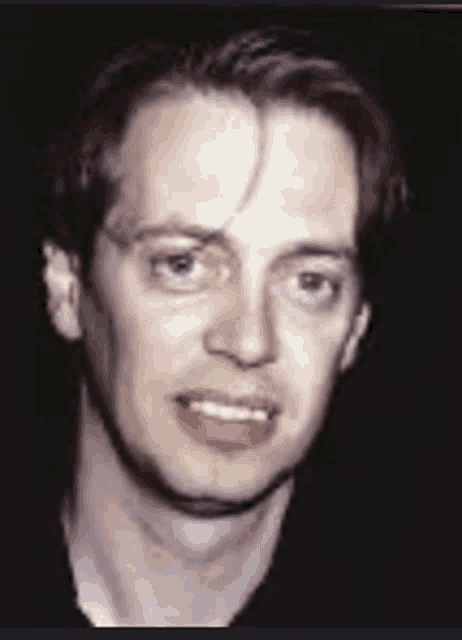 a close up of a man 's face with a dark background