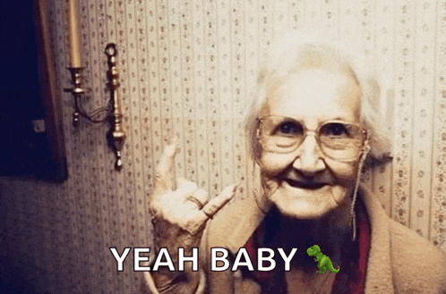 an elderly woman giving the middle finger with the words yeah baby written below her