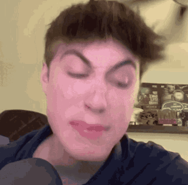 a close up of a man 's face with a sign in the background that says ' i love you '