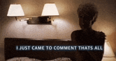 a woman is laying on a bed with the words " i just came to comment thats all " visible