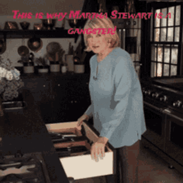 a woman opens a drawer in a kitchen with the words this is why martina stewart is a gangster