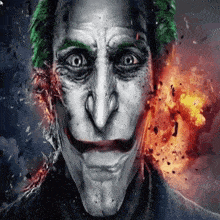 a close up of a joker 's face with fire behind him