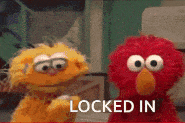 two sesame street characters are standing next to each other with the words locked in behind them