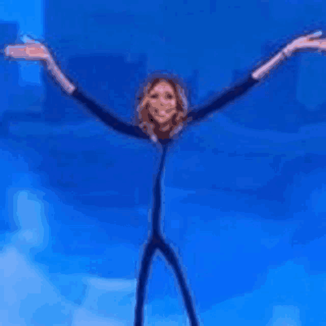 a woman with very long arms and legs is standing on a blue background .