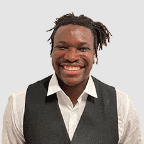 a man wearing a black vest and a white shirt smiles for the camera