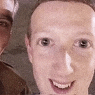 a close up of a man 's face and another man 's face in a blurry photo .