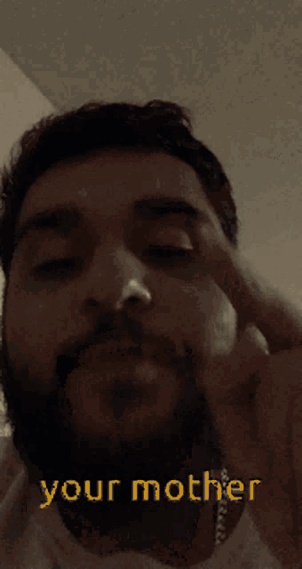 a close up of a man 's face with the words " your mother " below it