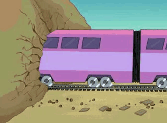 a pink train is going down the tracks next to a rocky hill .