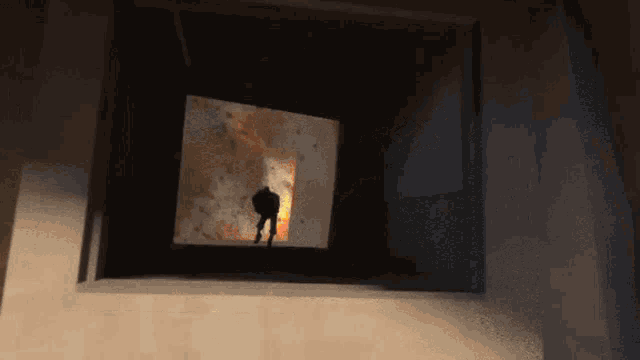 a silhouette of a man standing in front of a window