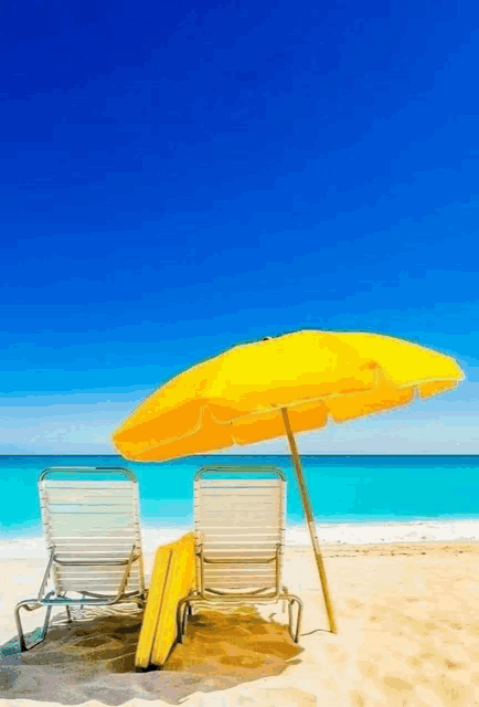 two beach chairs under a yellow umbrella on a sunny day