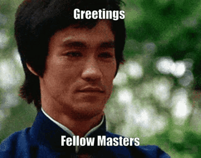 a man in a blue jacket with greetings fellow masters on his face